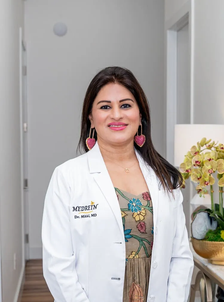 Dr. Haritha Mikkilineni, MD, in her lab coat at the Medrein Health clinic in Southlake, TX