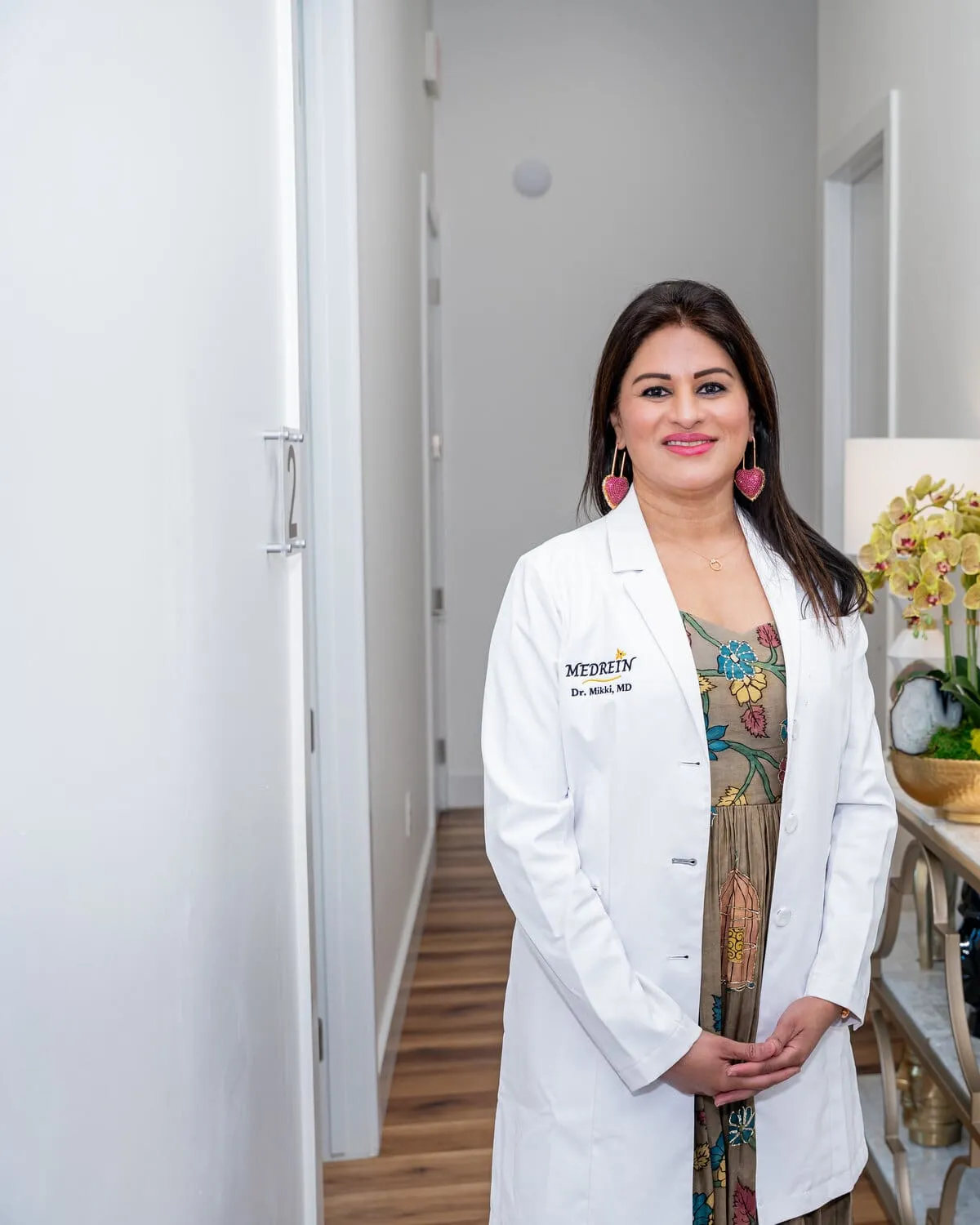Dr. Haritha Mikkilineni, MD, in her lab coat at the Medrein Health clinic in Southlake, TX