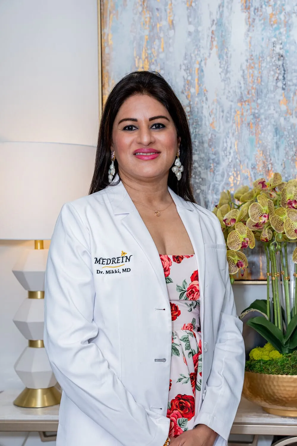 Dr. Haritha Mikkilineni, MD, founder and medical director of Medrein Health & Aesthetics, in her lab coat at the Southlake clinic