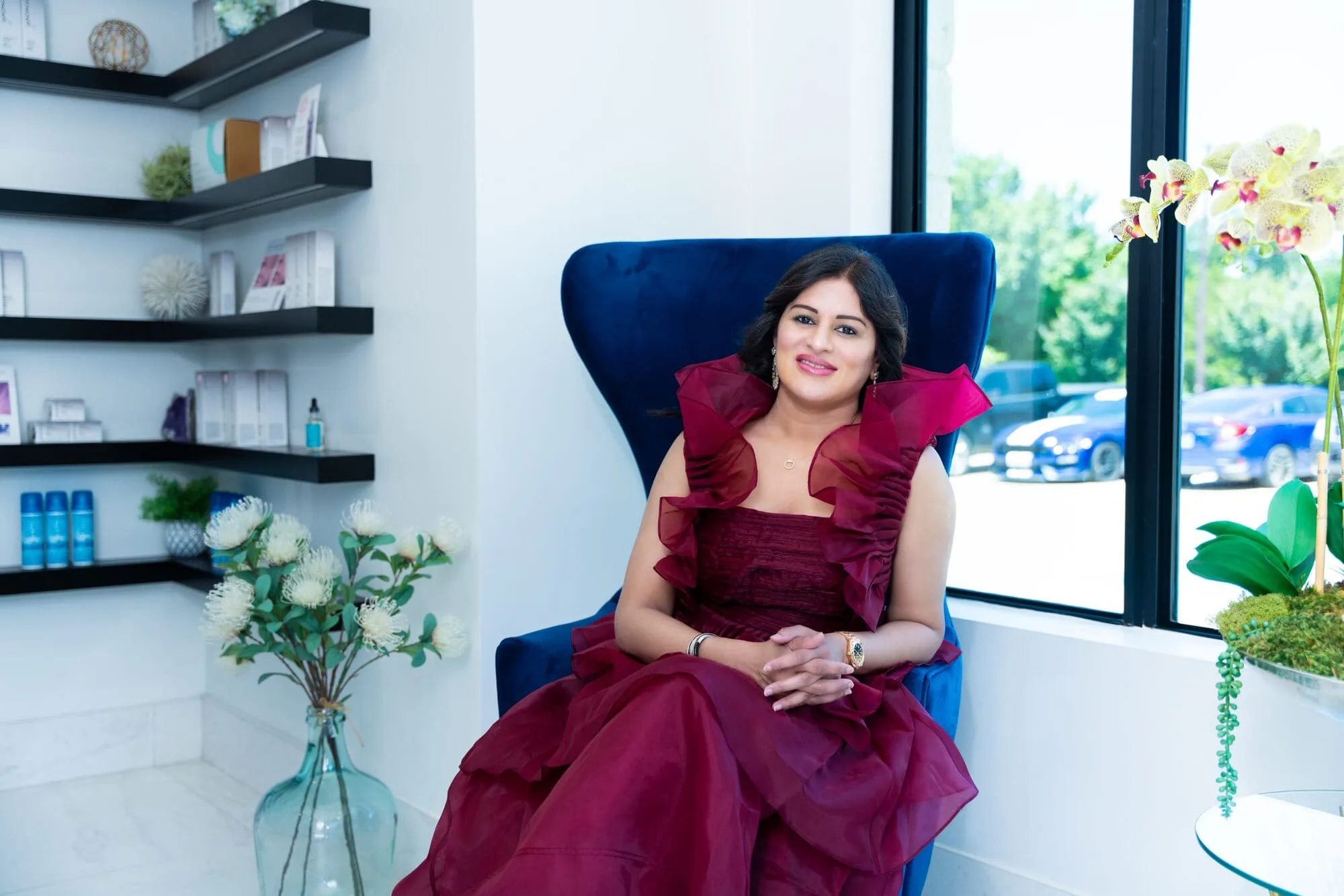 Dr. Haritha Mikkilineni, founder and medical director, seated in the Medrein Health & Aesthetics lounge in Southlake, TX