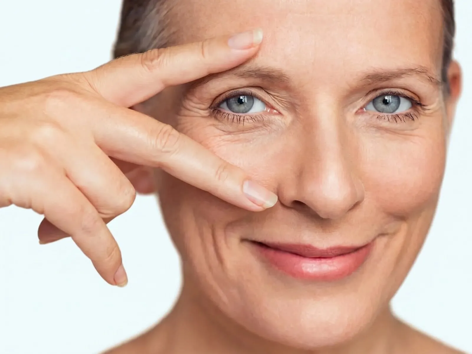 Close-up of the upper eyelid and brow area on a mature face, the region EyeLase firms