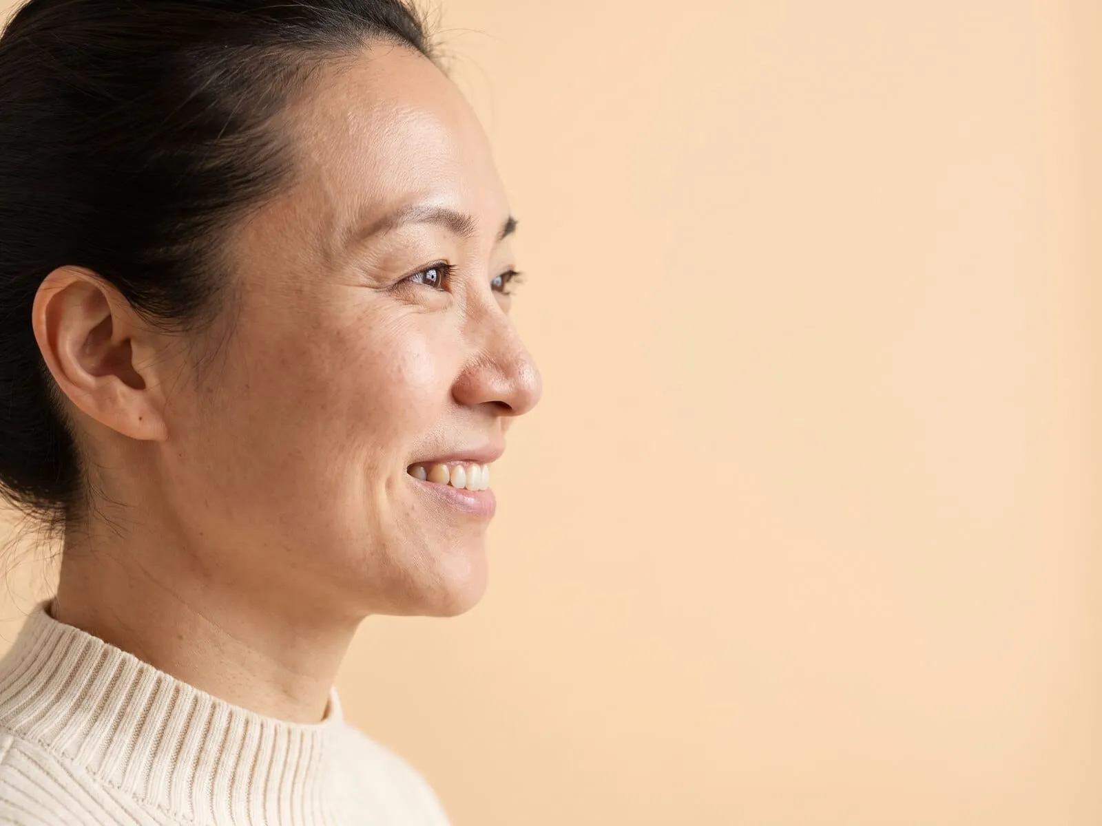 A woman photographed in profile, showing the bridge and the tip of the nose that a nose thread lift refines
